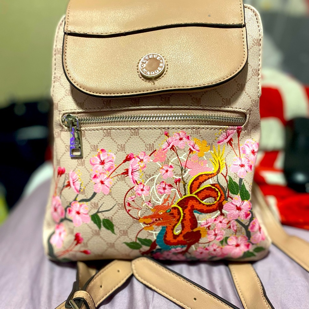 Creamy light tinted pink dragon design Steve Madden small backpack